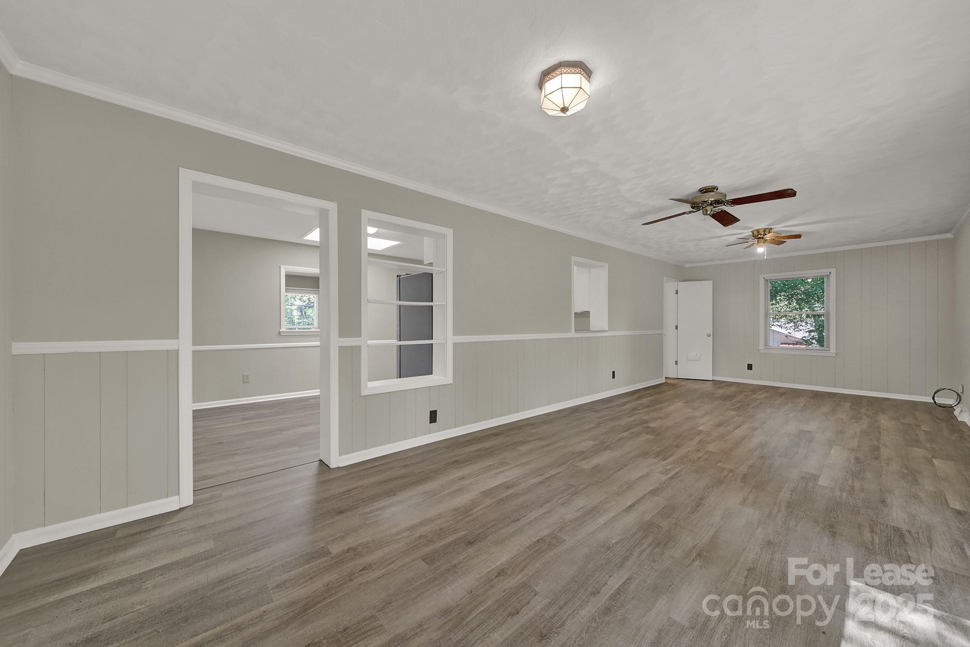 515 Wilcrest Drive Matthews, NC 28105 - Photo 9 of 19 an empty room with wooden floor and windows