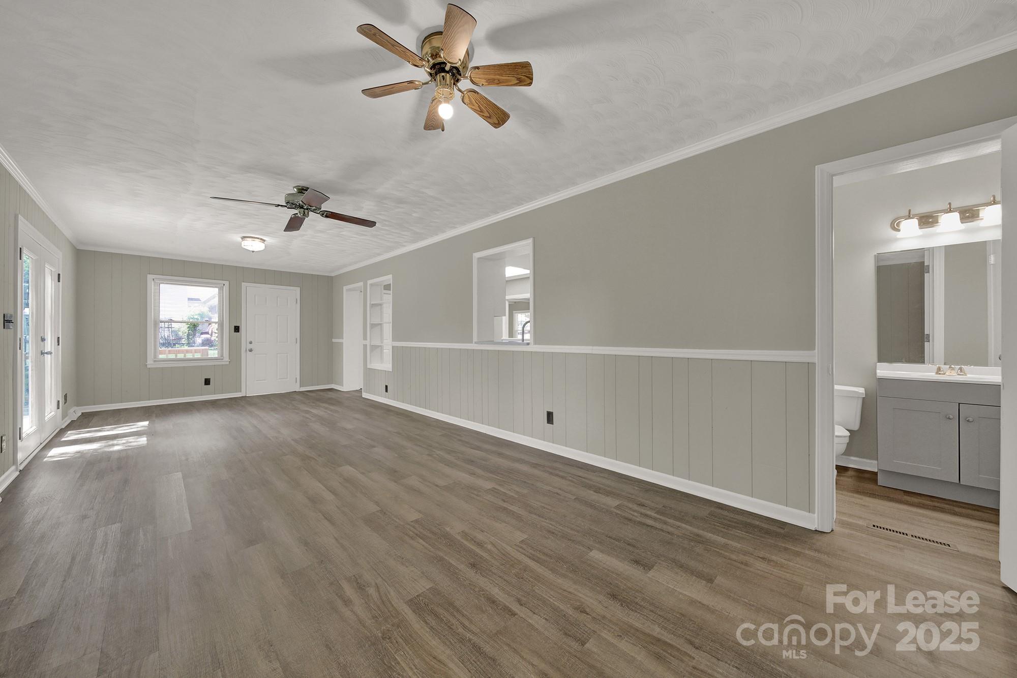 515 Wilcrest Drive Matthews, NC 28105 - Photo 10 of 19 a view of an empty room with a window and wooden floor