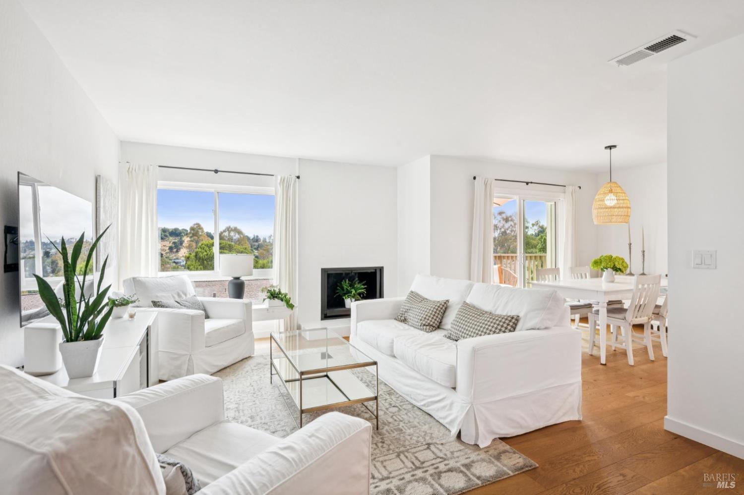 7 Emerson Drive Mill Valley, CA 94941 - Photo 1 of 1 a living room with furniture a fireplace a potted plant and a window