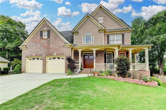 a front view of a house with a yard and porch