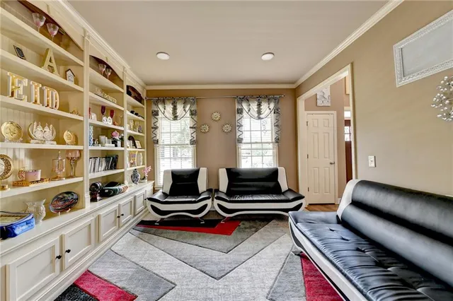 a living room with furniture a piano and a bookshelf