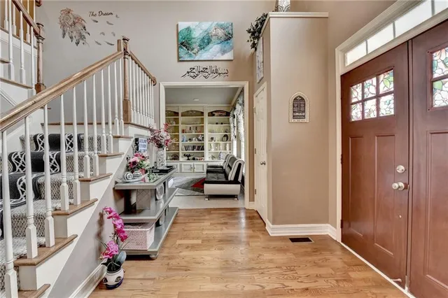 a view of an entryway with wooden floor