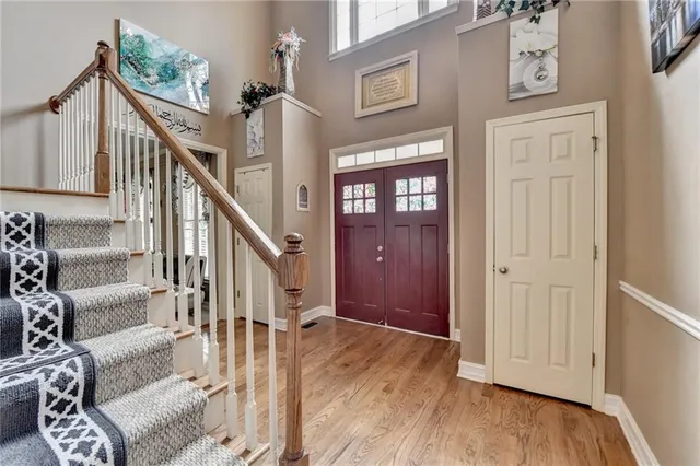 a view of entryway and hall with wooden floor