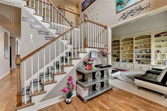 a living room with furniture and a book shelf