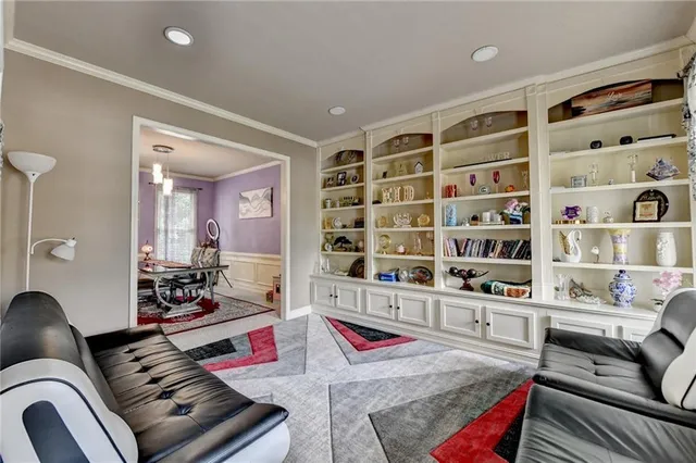 a living room with furniture cabinets and a rug