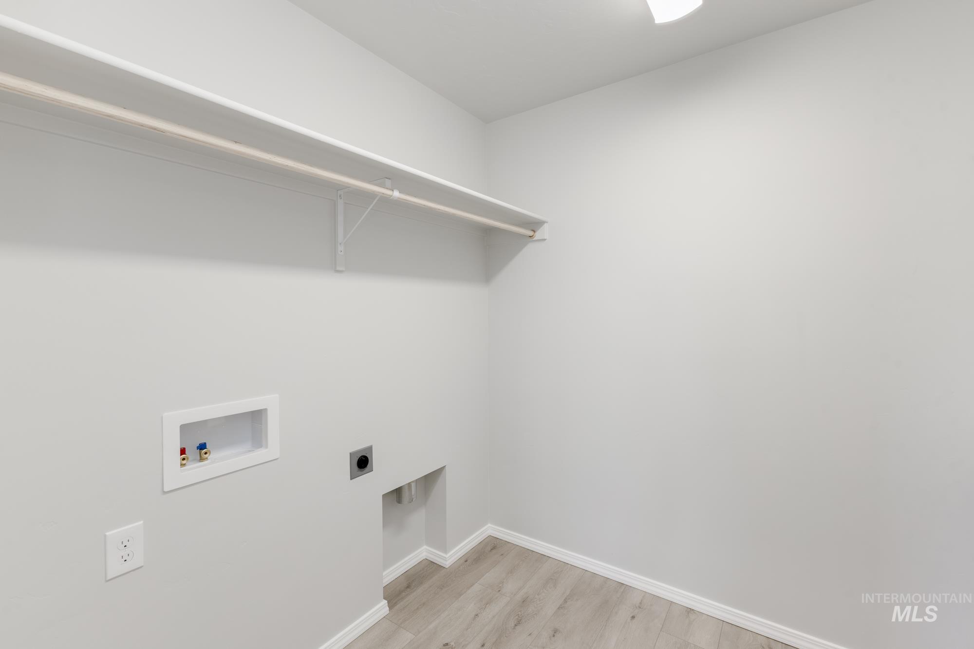12842 Ropers Street Nampa, ID 83651 - Photo 21 of 29 Utility room with light wood-finish flooring, white baseboards, and a neutral wall color