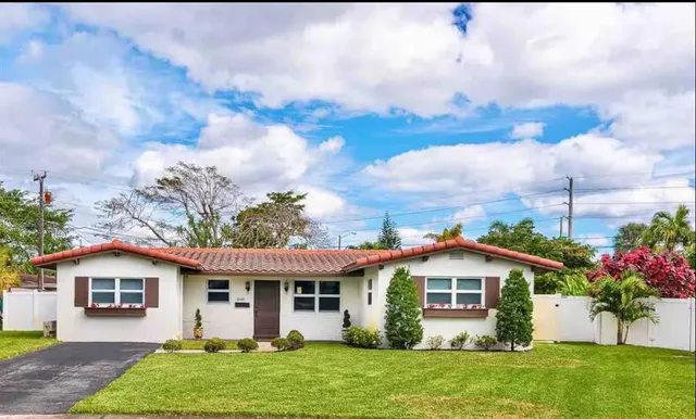 a front view of a house with a garden