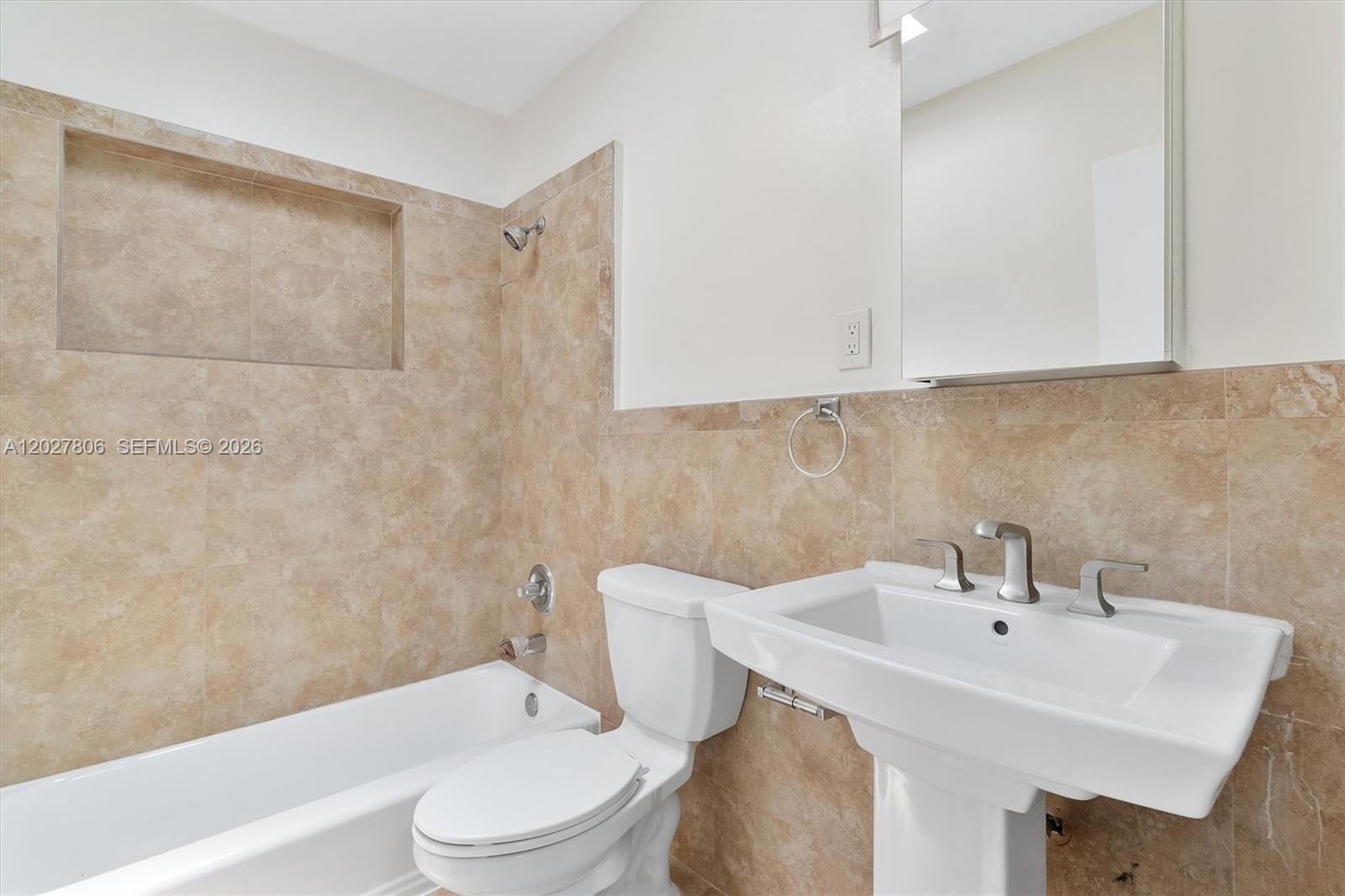 1612 Southwest 23rd Street, Unit 1612 Miami, FL 33145 - Photo 38 of 42 a bathroom with a sink a toilet and shower