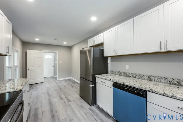 a kitchen with granite countertop wooden cabinets and a stainless steel appliances
