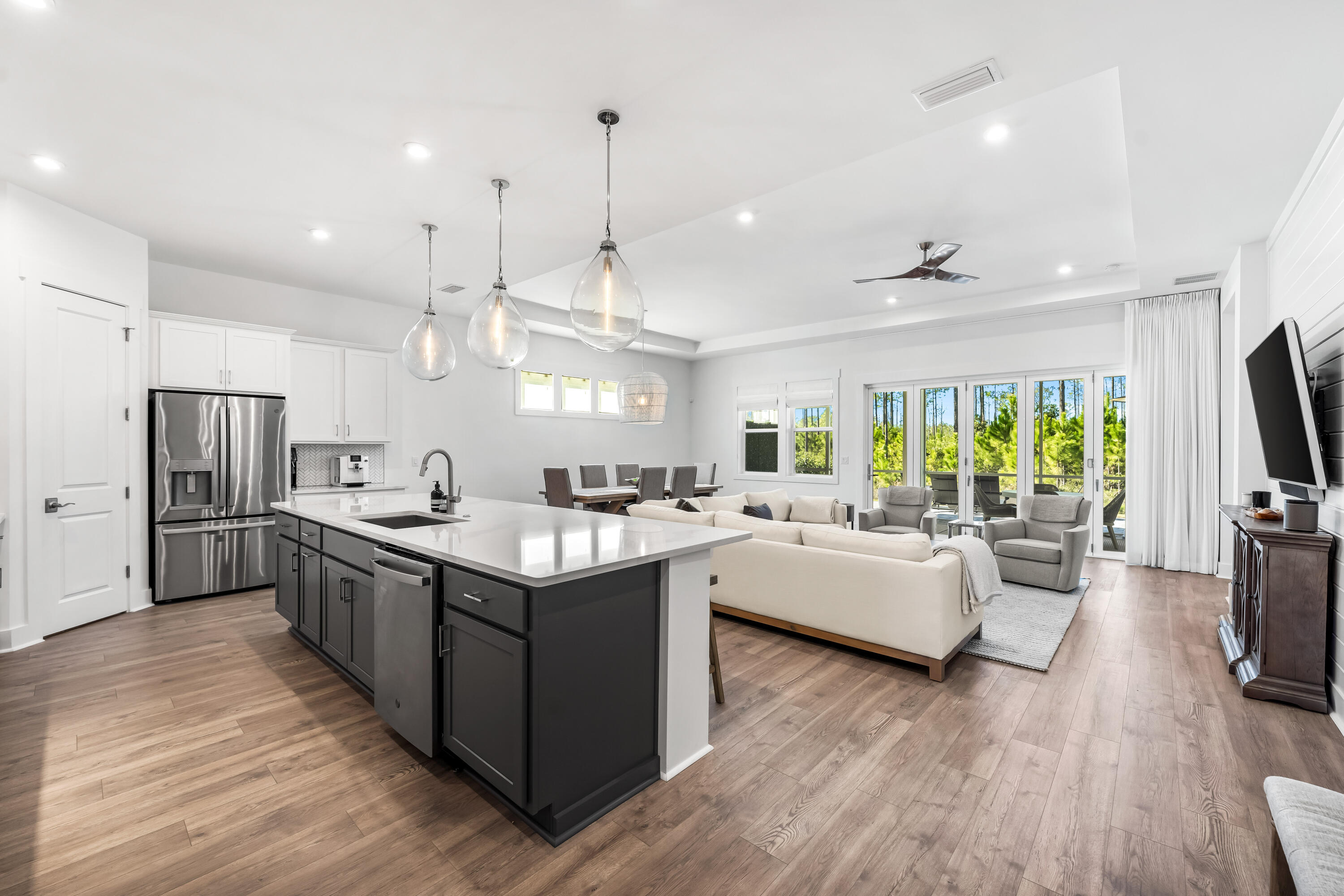 69 River Rise Way Watersound, FL 32461 - Photo 3 of 46 a kitchen with counter top space appliances and wooden floor