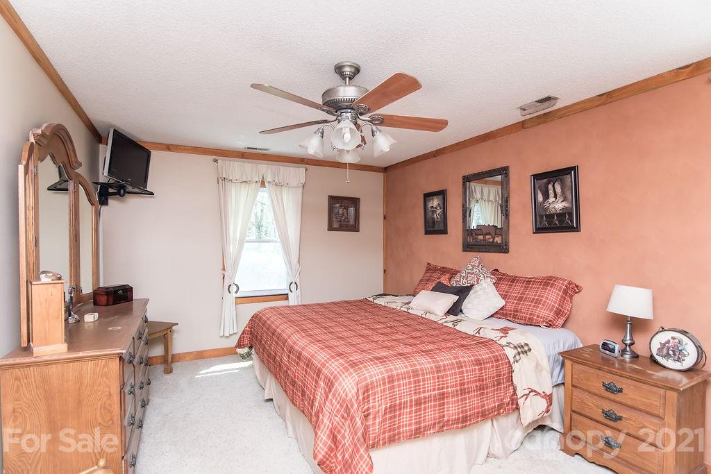 1791 Westbrook Road Edgemoor, SC 29712 - Photo 23 of 45 a bedroom with a bed and a chandelier