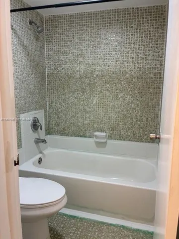a bathroom with a bathtub and toilet