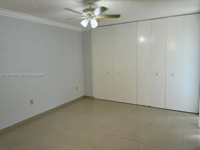a view of an empty room with a fan