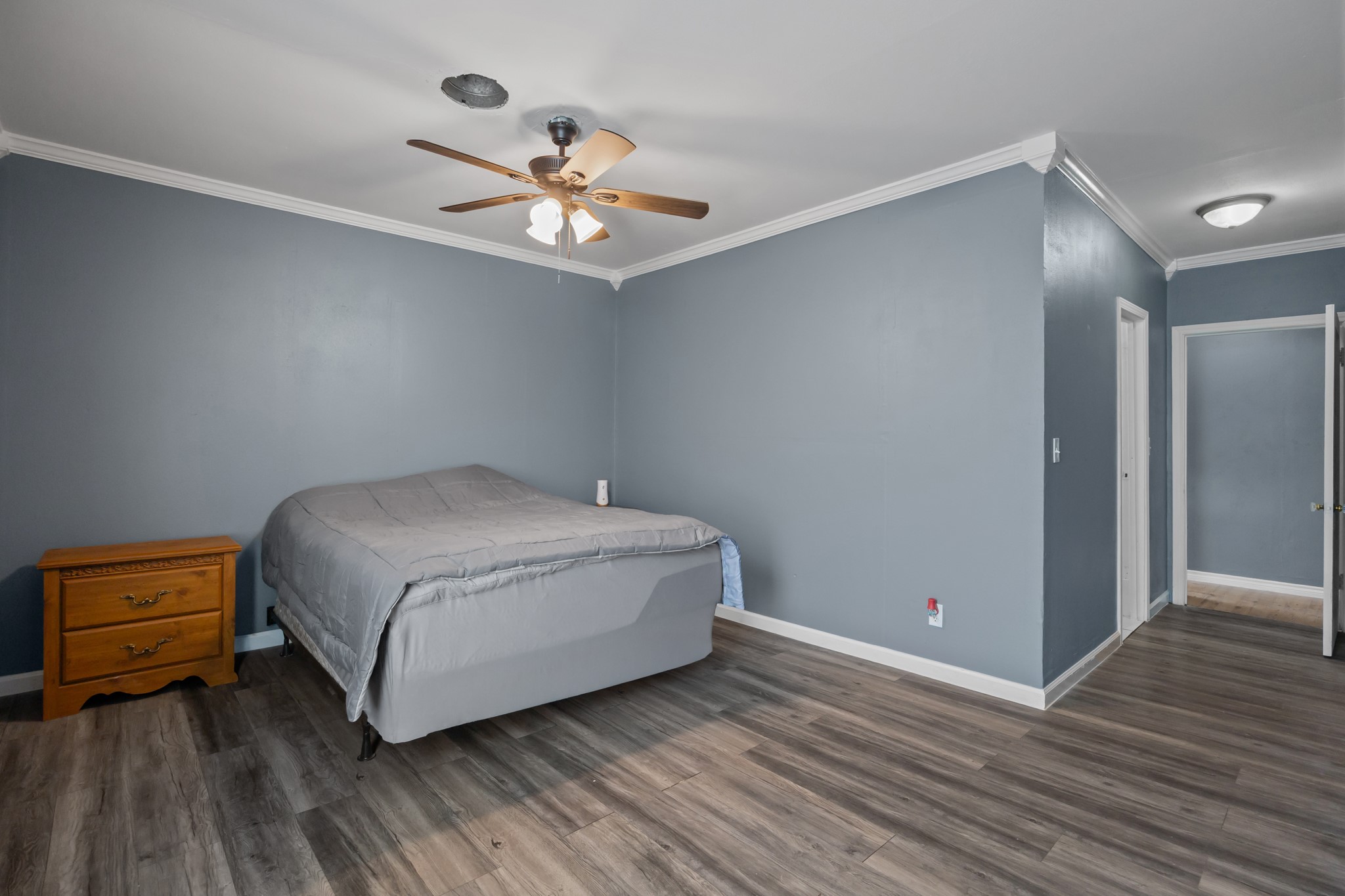 2006 Main Street Danbury, TX 77534 - Photo 18 of 30 a room with a bed and a chandelier