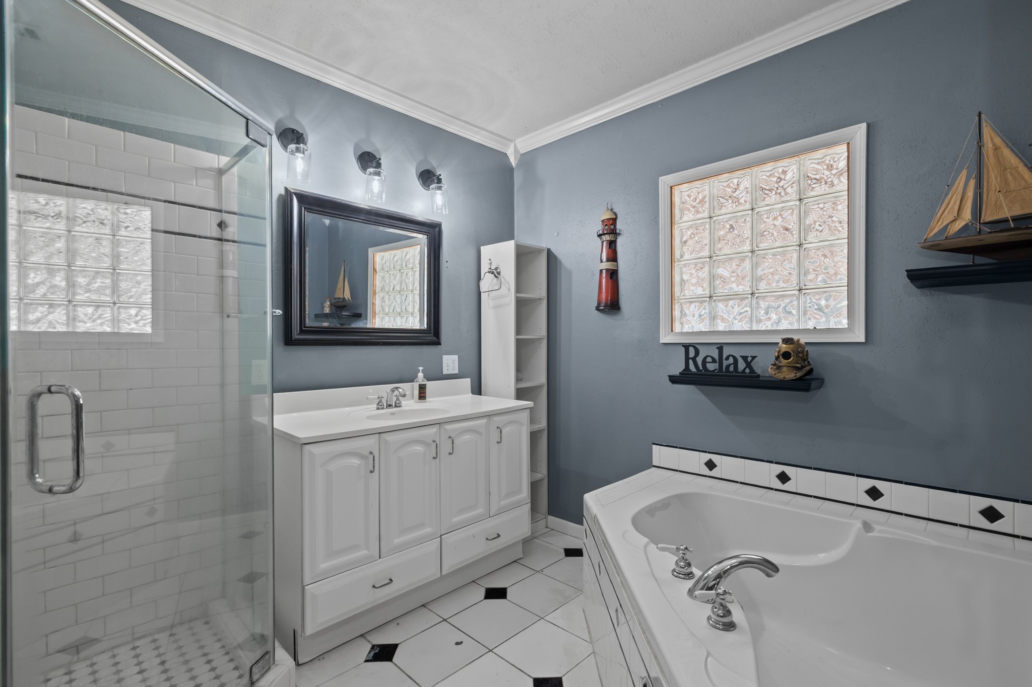 2006 Main Street Danbury, TX 77534 - Photo 19 of 30 a bathroom with a tub sink and mirror