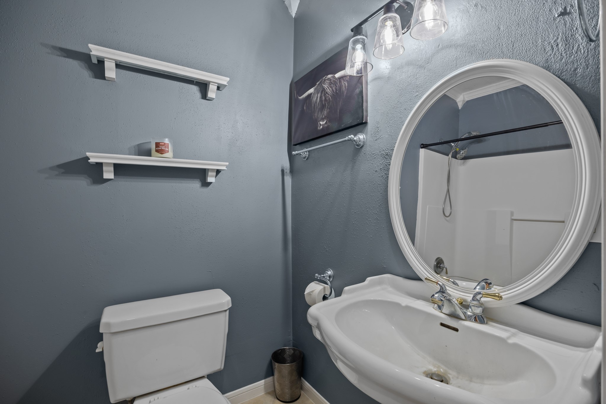 2006 Main Street Danbury, TX 77534 - Photo 22 of 30 a bathroom with a sink toilet and mirror