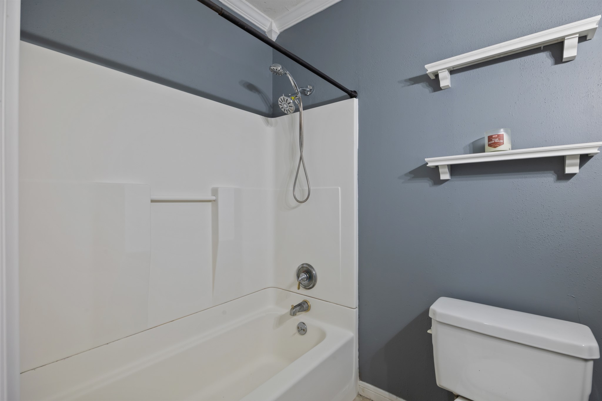 2006 Main Street Danbury, TX 77534 - Photo 23 of 30 a bathroom with a bath tub with a toilet