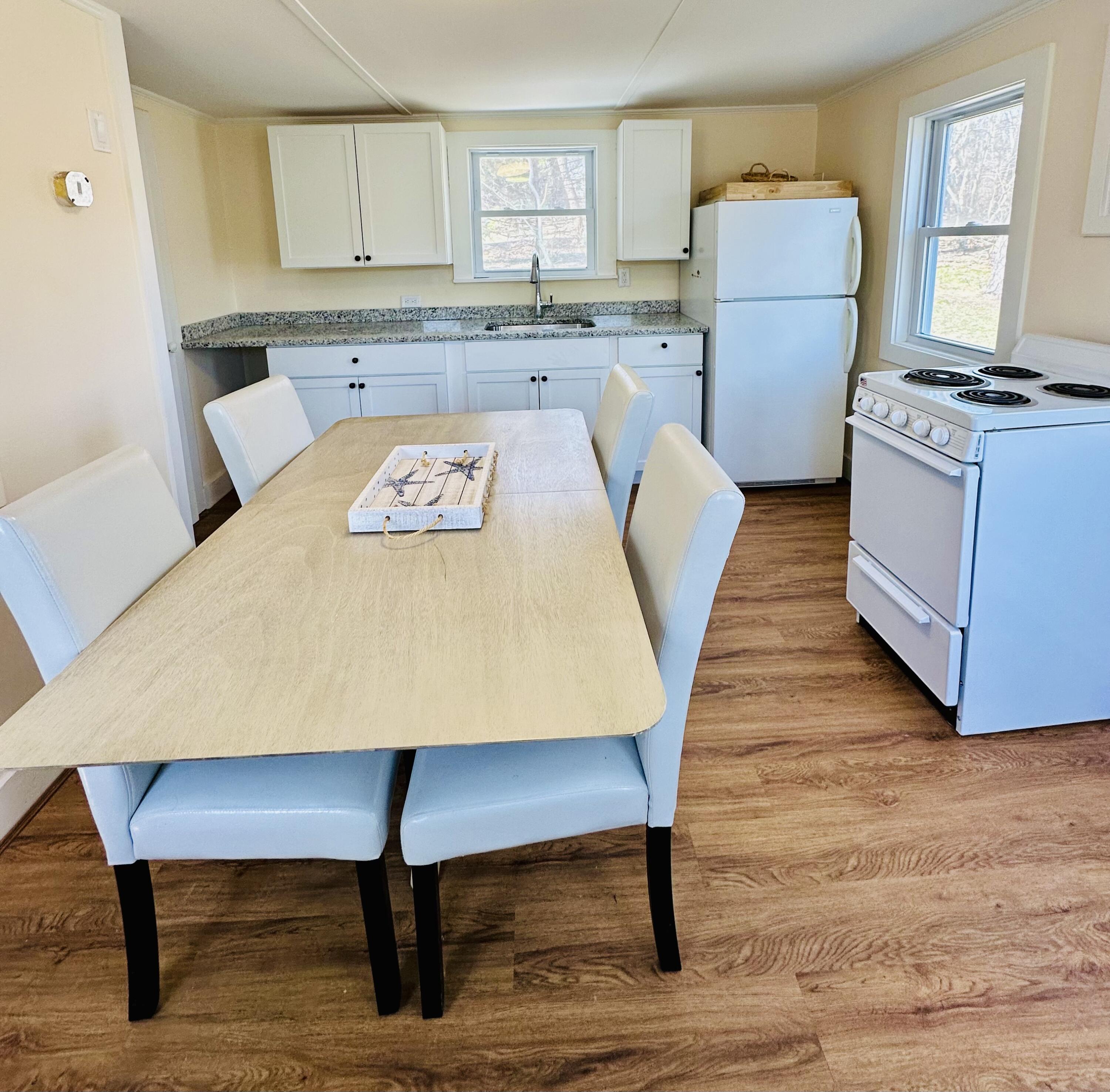 36 Cove Road Wellfleet, MA 02667 - Photo 13 of 22 a living room with a couch a dining table and white appliances