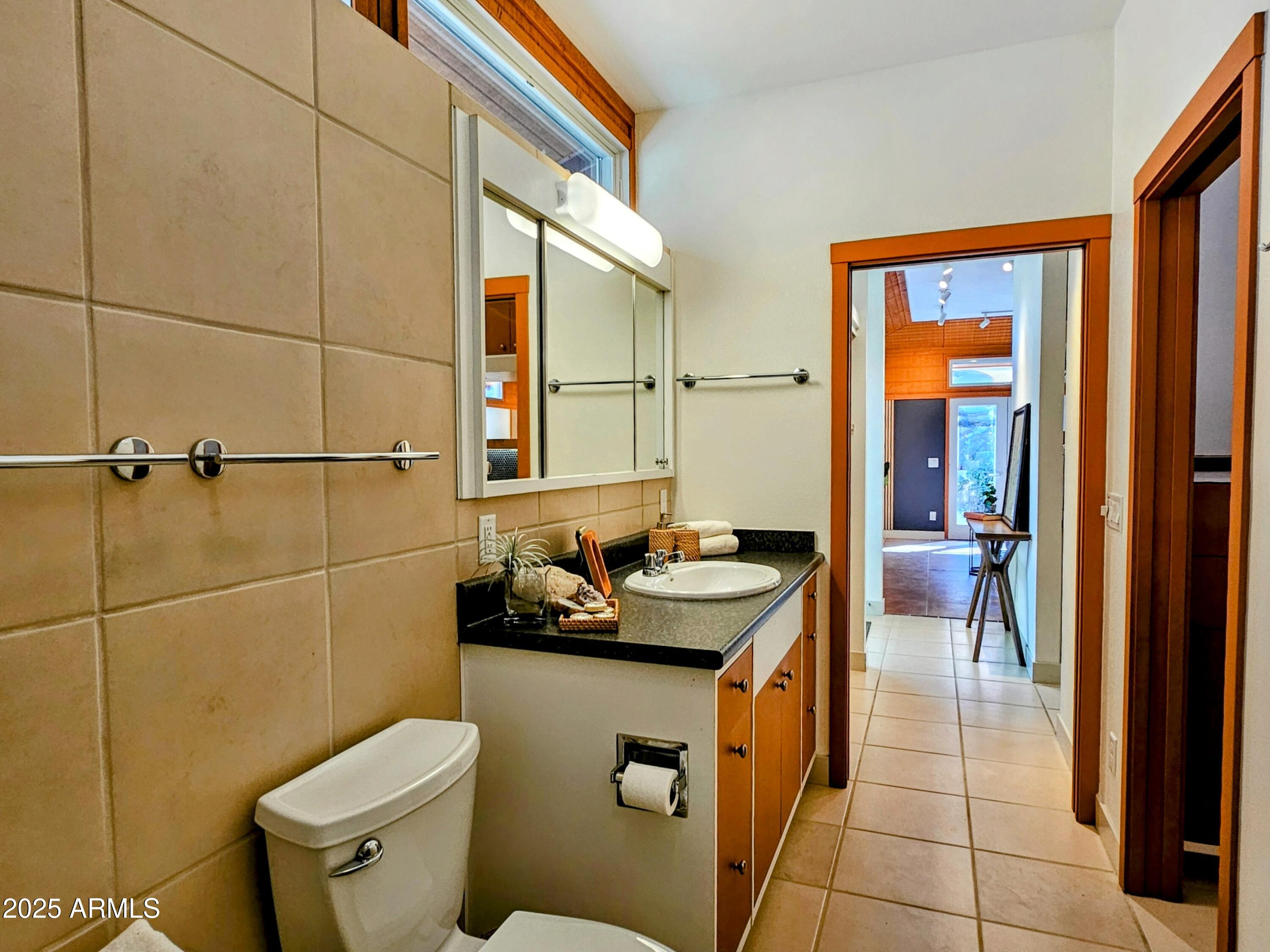 210 Opera Drive Bisbee, AZ 85603 - Photo 20 of 36 a bathroom with a granite countertop sink a toilet and shower