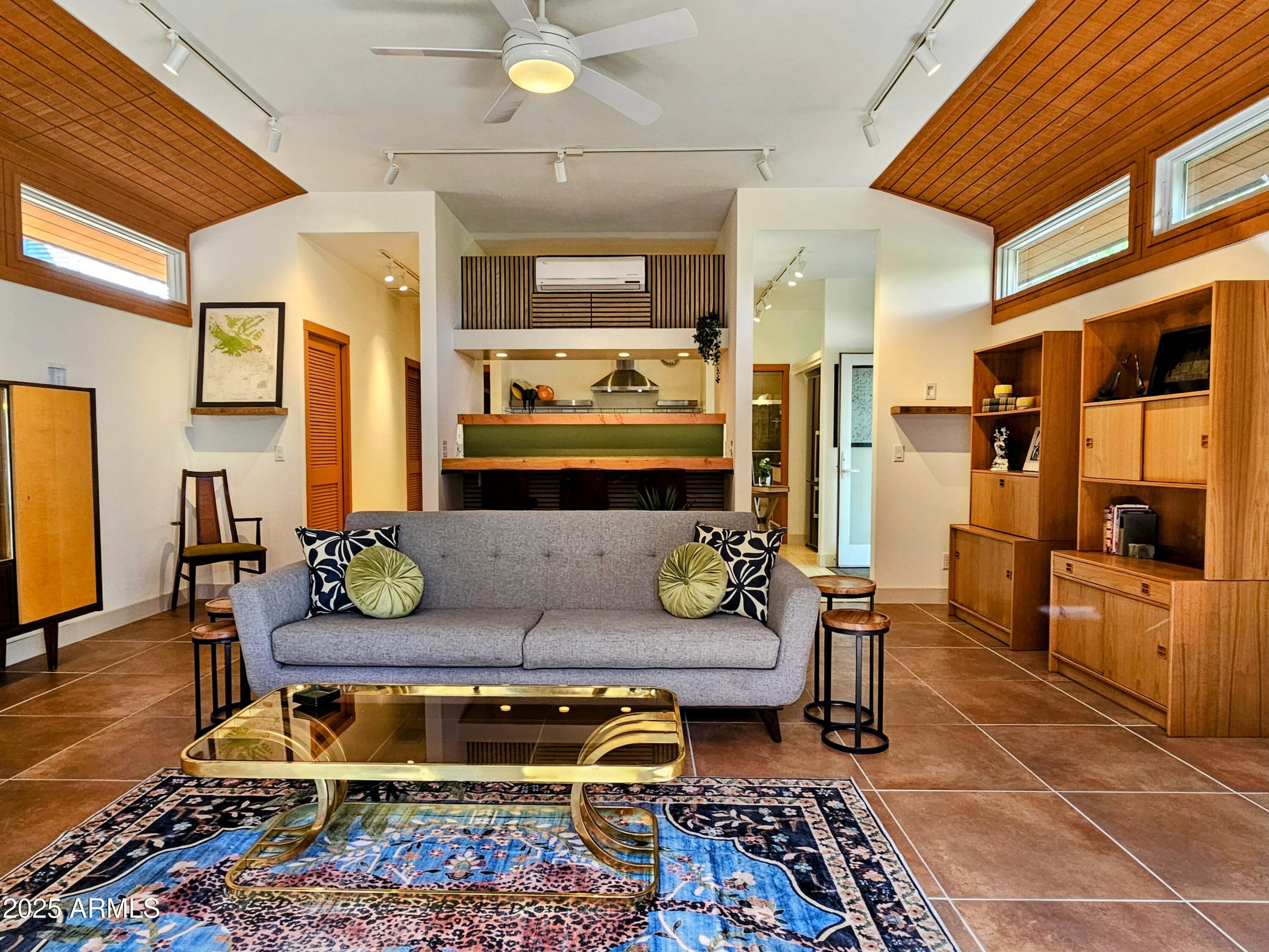 210 Opera Drive Bisbee, AZ 85603 - Photo 2 of 36 a living room with furniture a rug and kitchen view