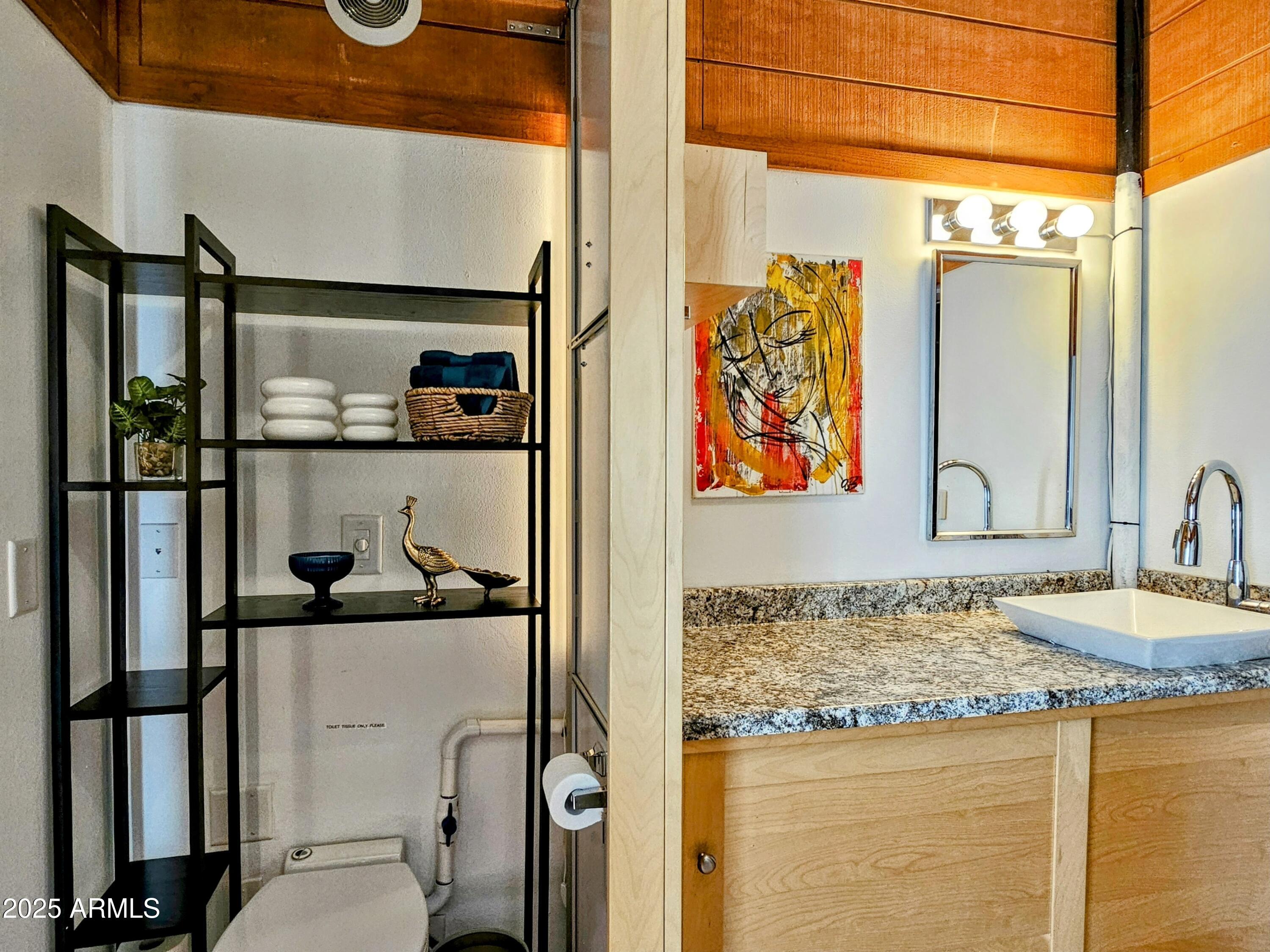 210 Opera Drive Bisbee, AZ 85603 - Photo 32 of 36 a bathroom with a granite countertop sink and a mirror