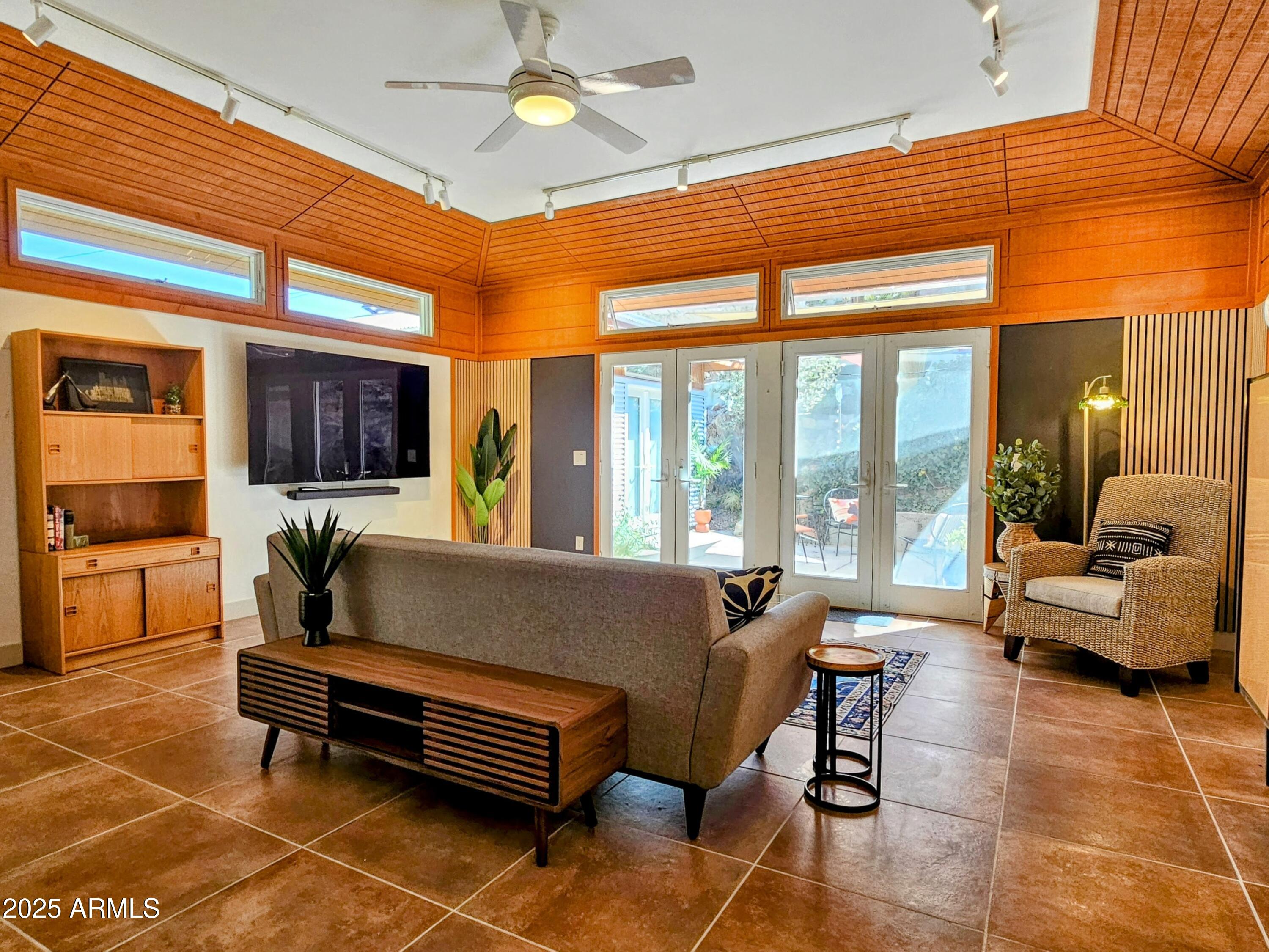 210 Opera Drive Bisbee, AZ 85603 - Photo 5 of 36 a living room with furniture a fireplace and a chandelier