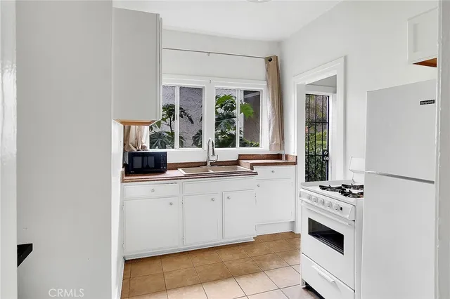 a kitchen with a refrigerator and cabinets