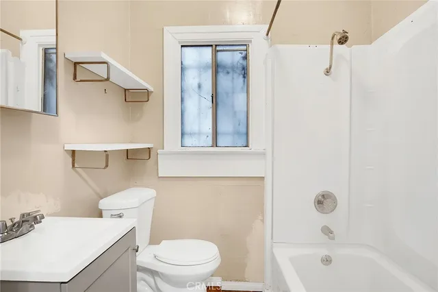 a spacious bathroom with a double vanity sink and a mirror