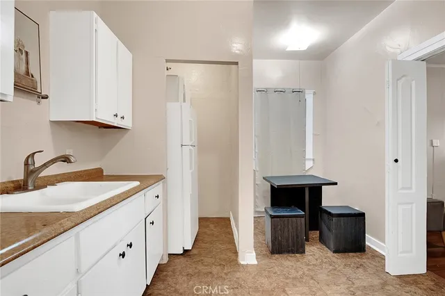 a kitchen with cabinets appliances and a sink