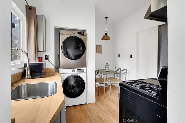 a living room with furniture and a view of kitchen