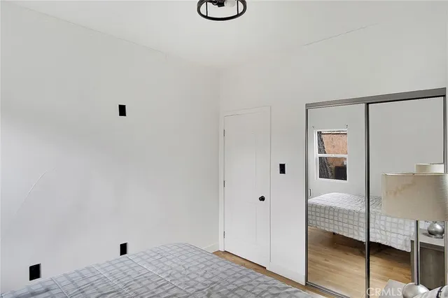 a bedroom with a bed and a lamp on table