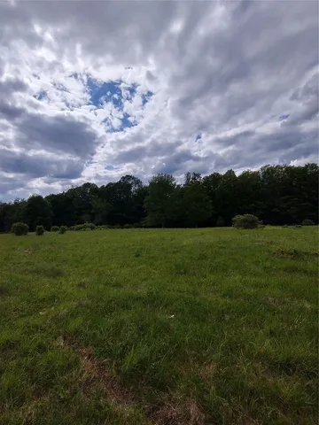 a backyard of a house with a table and chair