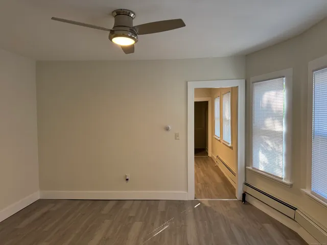 wooden floor in an empty room with a window