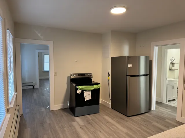 a kitchen with a refrigerator and a stove