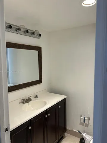 a bathroom with a sink vanity and a mirror