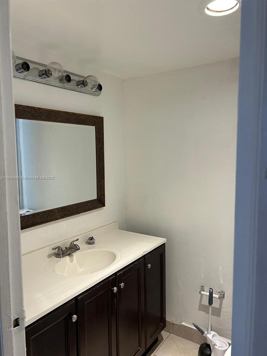 3671 Environ Boulevard, Unit 164 Lauderhill, FL 33319 - Photo 15 of 27 a bathroom with a sink vanity and a mirror