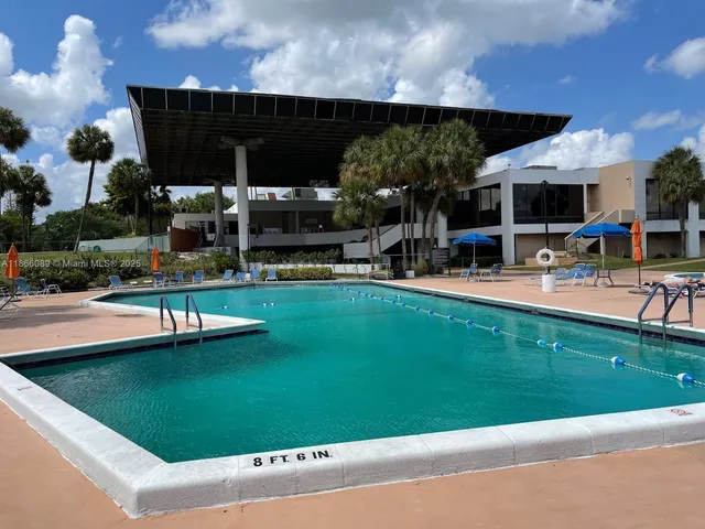 a house view with swimming pool and sitting space