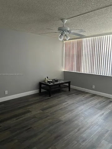 a view of room with wooden floor and window