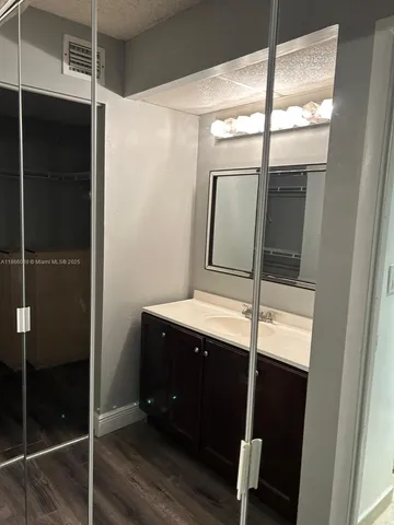 a bathroom with a shower and a sink