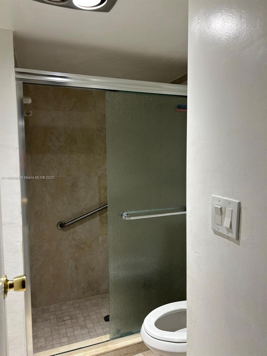 3671 Environ Boulevard, Unit 164 Lauderhill, FL 33319 - Photo 9 of 27 a bathroom with a shower and a toilet