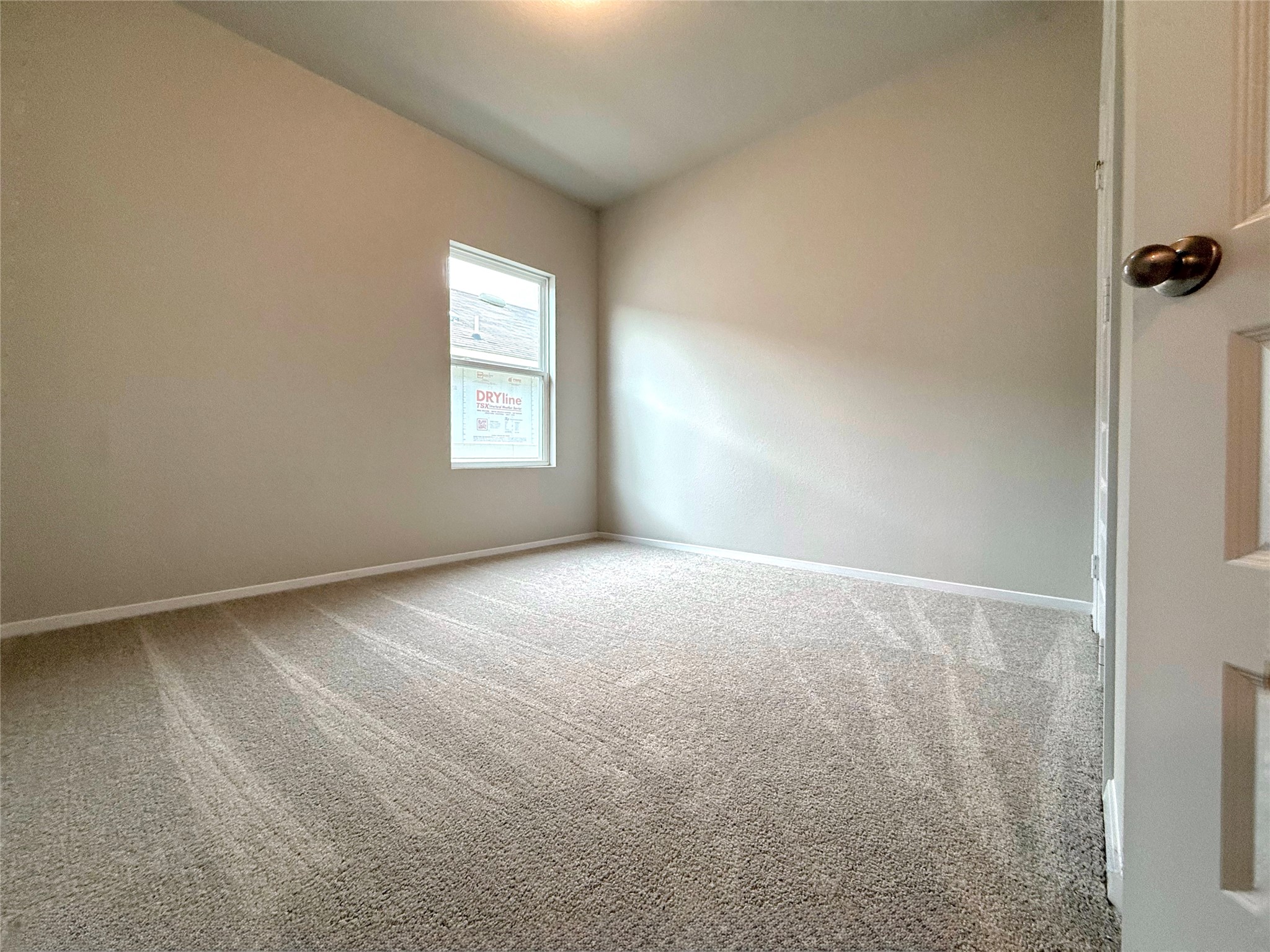 2714 Towy Road Manor, TX 78653 - Photo 16 of 22 A well-lit, neutral-toned bedroom awaits your personal touch and design vision.