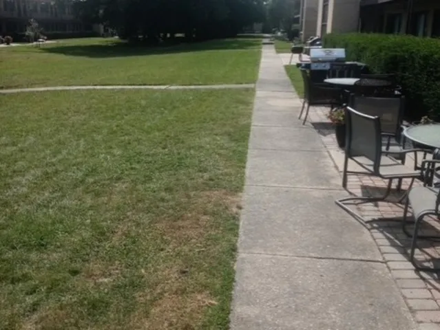 a view of a backyard with sitting area