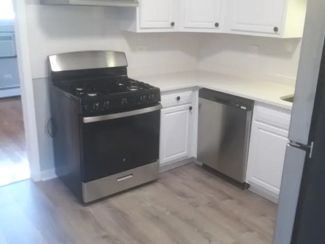 a kitchen with granite countertop a stove and a cabinets