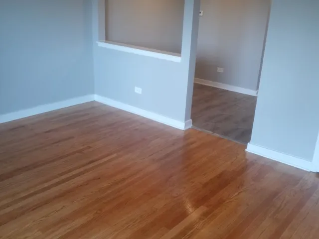 an empty room with wooden floor