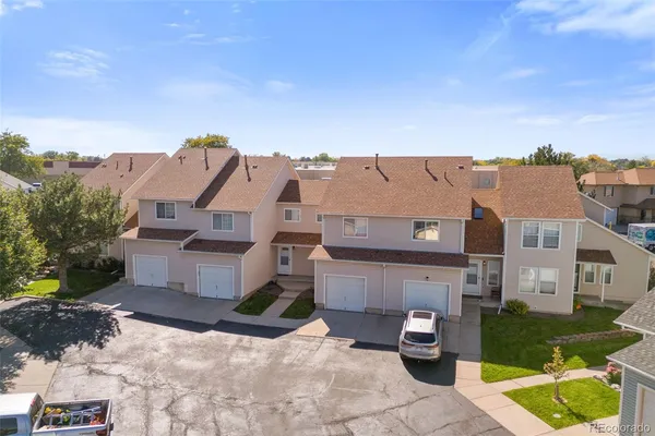 an aerial view of a house with a yard