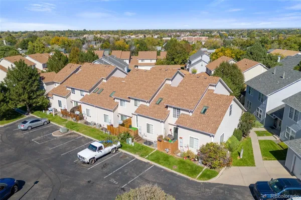 an aerial view of residential houses with outdoor space and ocean view