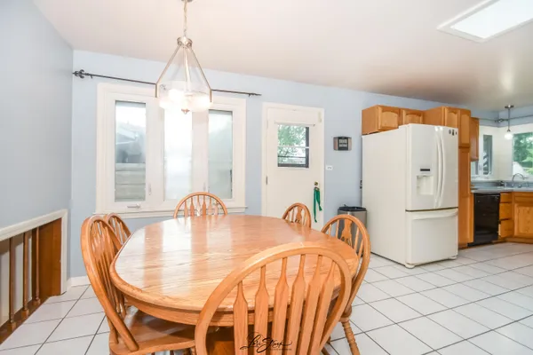 a dining room with furniture a table and chairs