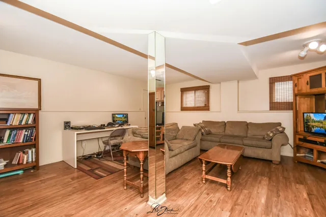 a living room with furniture and a book shelf