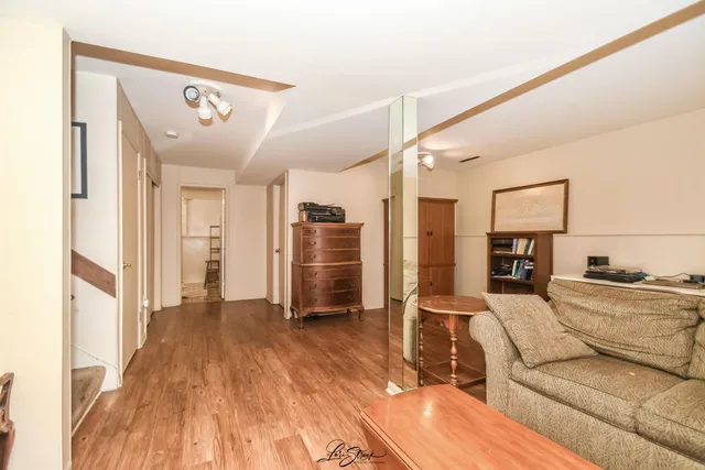 a living room with furniture and a wooden floor