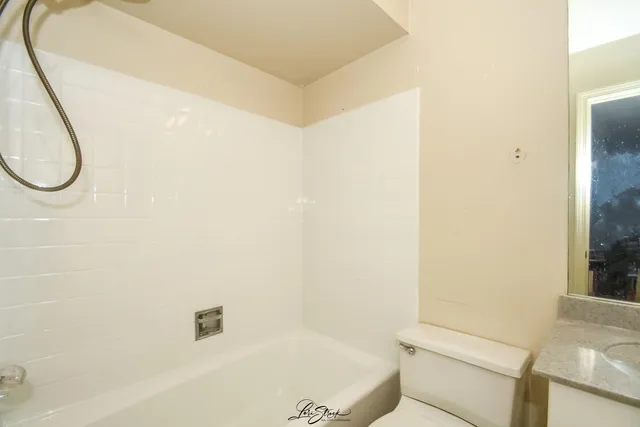 a bathroom with a tub and a shower